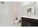 Elegant bathroom features a shower-tub combo with decorative tiling and a vanity with a marble countertop at 11719 Tetrafin Dr, Riverview, FL 33579