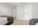 A cozy bedroom featuring two beds, neutral walls, and carpet flooring at 11719 Tetrafin Dr, Riverview, FL 33579