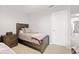 Bright bedroom features a comfy wooden bed frame, side table and carpet flooring at 11719 Tetrafin Dr, Riverview, FL 33579