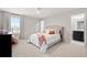 Light bedroom with ceiling fan, carpeted floor and large windows with plenty of natural light at 11719 Tetrafin Dr, Riverview, FL 33579