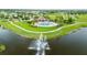 Aerial view of community amenities including a pool, splashpad, lake with fountain, and playground at 11719 Tetrafin Dr, Riverview, FL 33579