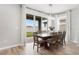 Dining room featuring a large wood table, modern lighting fixture, and sliding glass doors to the backyard at 11719 Tetrafin Dr, Riverview, FL 33579