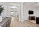Bright hallway with wood floors featuring views of the open living room at 11719 Tetrafin Dr, Riverview, FL 33579