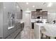 Modern kitchen with stainless steel refrigerator, sleek cabinets, and marble countertops at 11719 Tetrafin Dr, Riverview, FL 33579