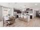 Spacious kitchen with marble island, dark cabinets, stainless appliances, and adjacent dining area at 11719 Tetrafin Dr, Riverview, FL 33579
