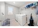 Functional laundry room with appliances and overhead storage, designed for convenience and efficiency at 11719 Tetrafin Dr, Riverview, FL 33579