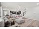 Bright living room features a sectional sofa, open floor plan, and modern kitchen at 11719 Tetrafin Dr, Riverview, FL 33579