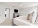 This main bedroom features neutral walls, a ceiling fan, and a dresser with a television on top at 11719 Tetrafin Dr, Riverview, FL 33579