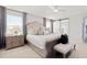 Main bedroom features a plush bed with cushioned headboard, ensuite bathroom, and soft neutral tones at 11719 Tetrafin Dr, Riverview, FL 33579