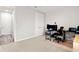 Neutral-toned room with a computer desk and rolling chair atop a patterned rug at 11719 Tetrafin Dr, Riverview, FL 33579