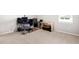 Neutral-toned office features a large computer desk and rolling chair atop a patterned rug at 11719 Tetrafin Dr, Riverview, FL 33579