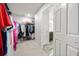 Large walk-in closet with built-in shelving, with view into a bathroom at 11719 Tetrafin Dr, Riverview, FL 33579