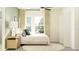 Bright bedroom with large windows, a cozy bed, and simple, elegant decor at 11836 Blue Diamond Trl, Parrish, FL 34219