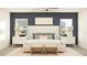 This bedroom boasts modern luxury with an elegant bed frame, stylish lamps and soothing blue accent wall at 11836 Blue Diamond Trl, Parrish, FL 34219