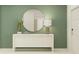Stylish entryway with a modern console table, mirror, and green accent wall at 11836 Blue Diamond Trl, Parrish, FL 34219