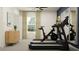 Bright exercise room with modern equipment including a treadmill and stationary bike at 11836 Blue Diamond Trl, Parrish, FL 34219