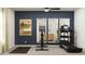 Well-equipped exercise room featuring a treadmill, stationary bike, and mirrored wall at 11836 Blue Diamond Trl, Parrish, FL 34219