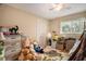 Neutral bedroom with fan, blinds, closet, toys and natural light at 12214 Buckingham Way, Spring Hill, FL 34609