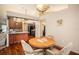 Cozy dining area featuring a modern light fixture, adjacent to an open kitchen with breakfast bar at 12214 Buckingham Way, Spring Hill, FL 34609