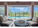 Screened-in pool area with outdoor seating, fire pit, and clear view at 12214 Buckingham Way, Spring Hill, FL 34609