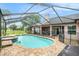 Screened-in pool and spa area with paver deck at 12214 Buckingham Way, Spring Hill, FL 34609
