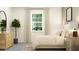 Serene bedroom with a fiddle leaf fig, soft textures, and natural light from a large window at 12313 Precious Ruby Way, Parrish, FL 34219
