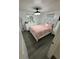 Stylish bedroom with a plush bed, modern lighting fixture, and elegant white furniture at 12502 Cambridge Ave, Tampa, FL 33624