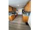 Well-lit kitchen featuring wood cabinetry, granite countertops, and stainless steel appliances at 12502 Cambridge Ave, Tampa, FL 33624