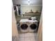 Functional laundry area equipped with a washer, dryer, and ample storage space at 12502 Cambridge Ave, Tampa, FL 33624