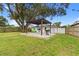 Spacious backyard with a new patio, pergola, barbecue, table and chairs at 12529 Mondragon Dr, Tampa, FL 33625