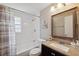 Well-lit bathroom featuring a tub/shower combo and a granite vanity at 12529 Mondragon Dr, Tampa, FL 33625