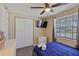 Well-lit bedroom featuring a queen bed, a TV, and closet space at 12529 Mondragon Dr, Tampa, FL 33625