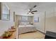 Charming bedroom features a queen bed, accent chair, and ample natural light at 12529 Mondragon Dr, Tampa, FL 33625