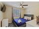 Cozy bedroom featuring a comfortable queen bed, a TV, and ample natural light at 12529 Mondragon Dr, Tampa, FL 33625