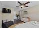 Well-lit bedroom featuring a queen bed, a TV, and ample natural light at 12529 Mondragon Dr, Tampa, FL 33625