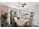 Bright dining room with a wooden table, stylish chairs, and sliding glass doors to the kitchen at 12529 Mondragon Dr, Tampa, FL 33625
