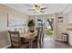 Bright dining room with a wooden table, stylish chairs, and sliding glass doors to the backyard at 12529 Mondragon Dr, Tampa, FL 33625