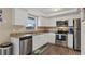 Well-lit kitchen with stainless steel appliances, granite countertops, and ample cabinet space at 12529 Mondragon Dr, Tampa, FL 33625