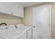 Functional laundry room with modern appliances and ample storage space at 12529 Mondragon Dr, Tampa, FL 33625