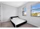 Minimalist bedroom features neutral carpet, large windows, and a stylish platform bed for a modern, uncluttered feel at 1330 W Gray St # 2, Tampa, FL 33606