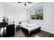 Modern bedroom with dark wood floors, a sleek platform bed, and plenty of natural light from the large window at 1330 W Gray St # 2, Tampa, FL 33606