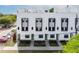 Townhome with green doors, striking window features, and well-manicured landscaping at 1330 W Gray St # 2, Tampa, FL 33606