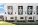 Modern townhome exterior with eye-catching window frames and lush landscaping at 1330 W Gray St # 2, Tampa, FL 33606