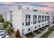 Modern townhouse exterior featuring unique window accents, private entrances, and well-maintained landscaping at 1330 W Gray St # 2, Tampa, FL 33606