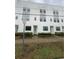 Townhome community displaying modern facades with green doors and landscaped walkways at 1330 W Gray St # 2, Tampa, FL 33606