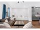 Bright living room with hardwood floors, two sofas, and a sleek entertainment center at 1330 W Gray St # 2, Tampa, FL 33606