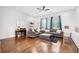 Bright living room featuring hardwood floors, recessed lighting, and two comfortable sofas with large windows at 1330 W Gray St # 2, Tampa, FL 33606