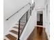 Modern staircase with hardwood steps, sleek black railing, and access to the upper floors at 1330 W Gray St # 2, Tampa, FL 33606