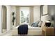 Cozy bedroom with a plush bed, designer pillows, and large windows with sheer curtains at 13510 White Gold Run, Parrish, FL 34219