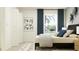 Bright bedroom with neutral decor, a window with blue drapes, and modern art at 13510 White Gold Run, Parrish, FL 34219